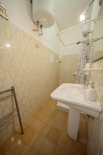 a bathroom with a white sink and a shower at Gemma Del Sud - Centro Storico in Conversano