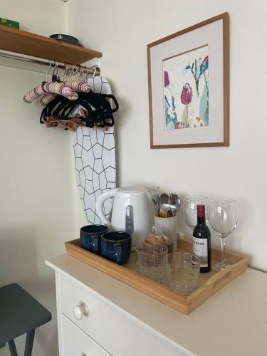 a shelf on a kitchen counter with wine glasses at Ground floor double with en suite shower room in Brighton & Hove
