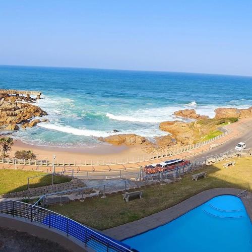 a view of a beach and the ocean with a bridge at Whale Rock in Margate