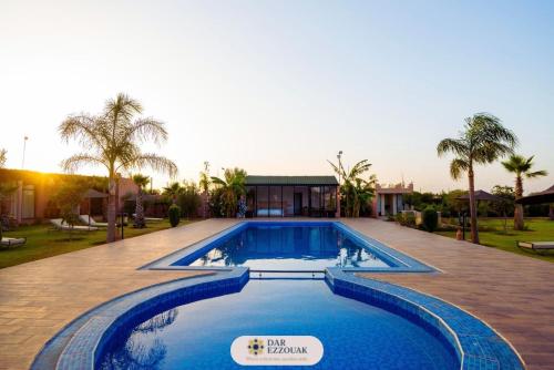 a swimming pool in the middle of a yard at Dar Ezzouak in Heddad