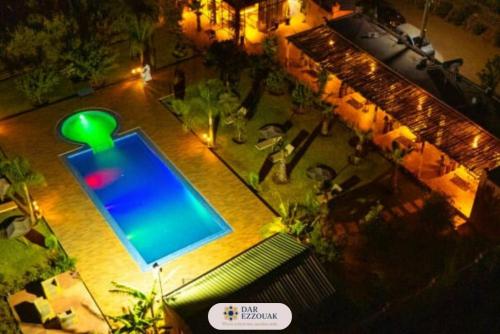 an overhead view of a swimming pool at night at Dar Ezzouak in Heddad