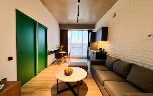 a living room with a couch and a table at Rooms Apart Hotel by RED in Yerevan
