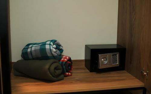 a room with a microwave and a pillow next to a toaster oven at Rooms Apart Hotel by RED in Yerevan