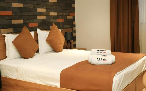 a bedroom with a bed with two towels on it at Rooms Apart Hotel by RED in Yerevan