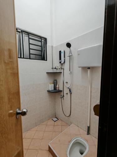 a bathroom with a shower and a toilet at Aii Minsu in Kluang