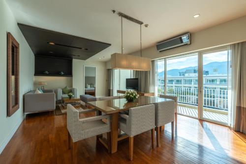 a living room with a dining room table with a view at Kantary Hills Hotel, Chiang Mai in Chiang Mai