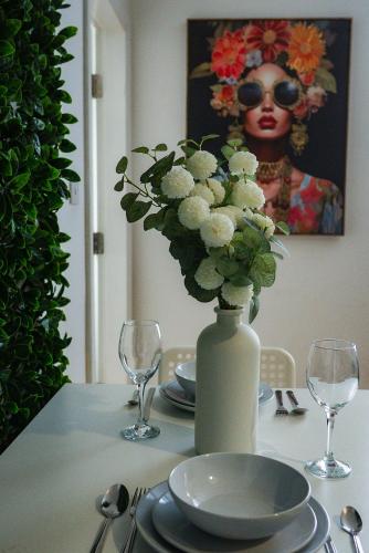 a table with a vase with white flowers on it at belgian studio Apt 2 in Huddersfield
