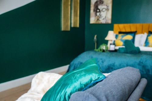 a bedroom with a bed with a blue bed at belgian studio Apt 2 in Huddersfield