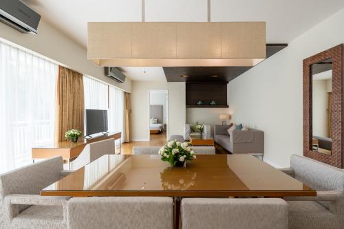 a living room with a table and chairs at Kantary Hills Hotel, Chiang Mai in Chiang Mai