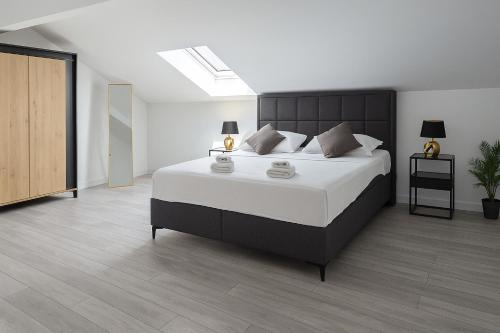 a bedroom with a large bed and a skylight at Apartment 5237-3 in Batalaži