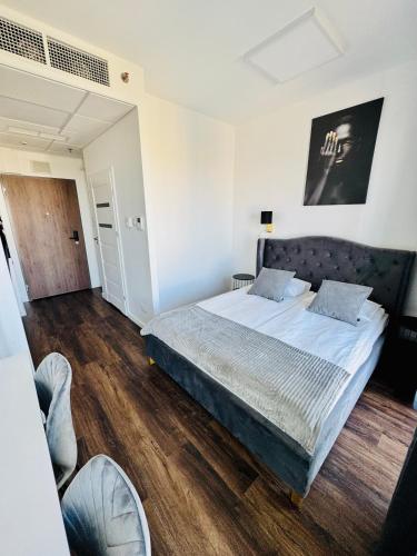 a bedroom with a large bed in a room at Vola Palace in Warsaw