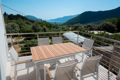 a table and chairs on a balcony with a view at Marianna's and Aristidis' houses in Sívros
