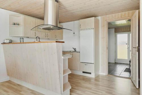 a kitchen with white cabinets and a counter top at 115-Harboore-Strandvejen-164 in Harboør