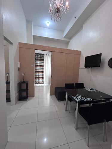 a living room with a couch and a table at Wind and Sea at Wind Residences in Tagaytay