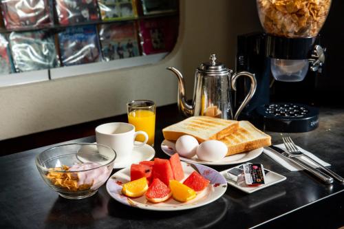 two plates of breakfast food on a counter with eggs and fruit at Shimaya in Yamanouchi