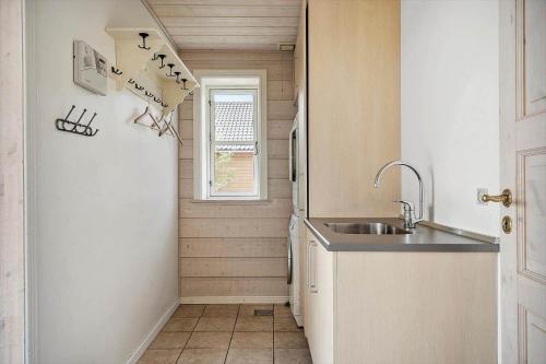 a small kitchen with a sink and a window at 289-Harboore-Strandvejen-179 in Harboør