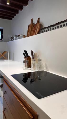 a kitchen counter with a black counter top at Bait Rawiyah experience an authentic Omani house in Muscat