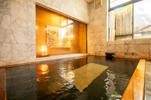 a room with a pool of water in a building at Shimaya in Yamanouchi