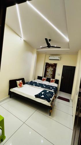 a bedroom with a bed and a ceiling fan at Shree nidhi comfort stay MAHAKAL ki krupa ujjain in Ujjain