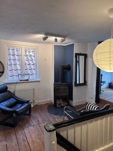 a living room with a couch and a fireplace at Altstadthaus No 18 in Lübeck