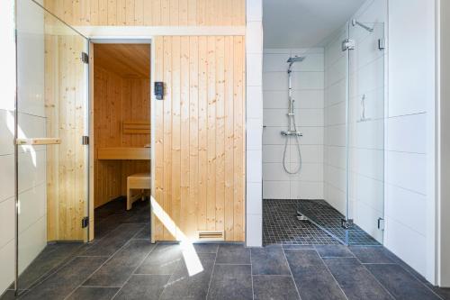 a bathroom with a shower and a glass door at Wellenzauber in Kellenhusen