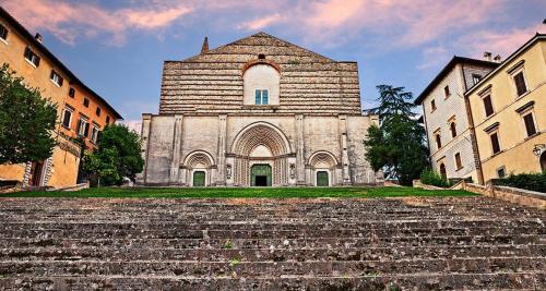 an old church with stairs in front of it at Torre Paola Dimora romantica in Acquasparta