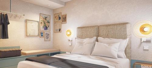 a bedroom with a large bed with white pillows at Hotel Ben Marsalforn, Affiliated by Meliá in Marsalforn