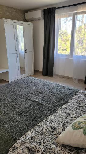 a bedroom with a large bed and a window at Hotel Country Mornings in Kragujevac