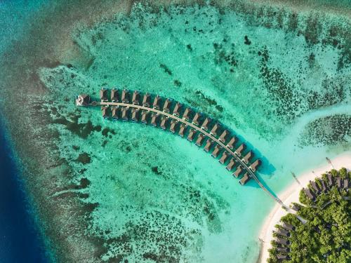 an aerial view of a pier on a beach at ROBINSON NOONU - All Inclusive in Manadhoo