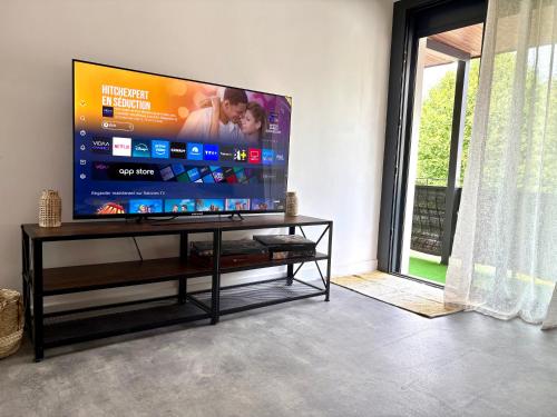 a living room with a large flat screen tv at Un havre de Paix entre Paris et Disney in Le Plessis-Trévise