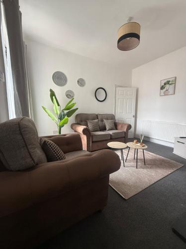 a living room with a couch and a table at ResiLets 1st Floor apartment in Blythe