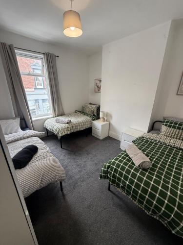 a bedroom with two beds and a window at ResiLets 1st Floor apartment in Blythe