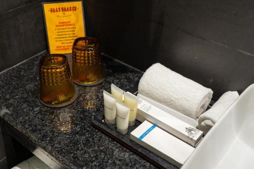 a counter with someented candles and towels on it at Gaas BaasCo in Kathmandu