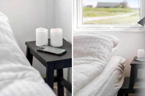 a table with a bed and a window with a phone on it at 509-Lemvig-Stranden-11 in Lemvig