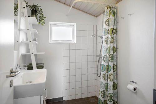 a bathroom with a shower curtain and a sink at 509-Lemvig-Stranden-11 in Lemvig