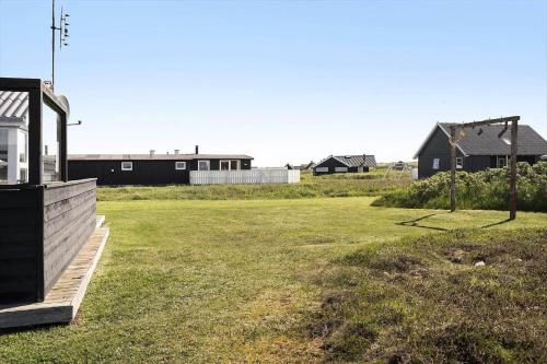 a field of grass with houses in the background at 509-Lemvig-Stranden-11 in Lemvig