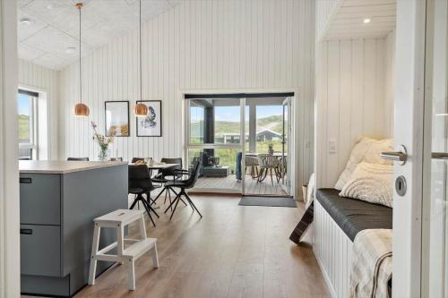 a kitchen and living room with a couch and a table at 341-Harboore-Gloryvej-27 in Harboør