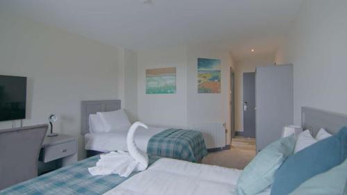 a hotel room with two beds and a tv at The Saratoga in Waterford