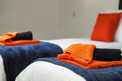 a pile of towels sitting on top of a bed at Private & Peaceful Double Ensuite Rooms in Stapleford in Stapleford