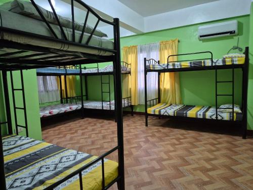 a room with three bunk beds in a room at Mandy in Tuguegarao City