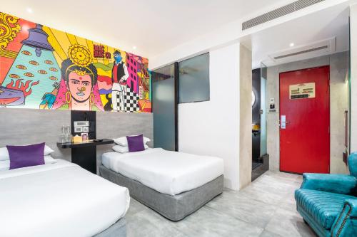a hotel room with two beds and a couch at Gaas BaasCo in Kathmandu