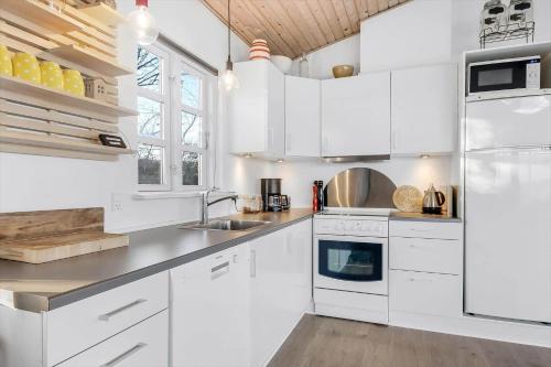 a white kitchen with white cabinets and a sink at G107-Lemvig-Sogardevejen-7 in Lemvig