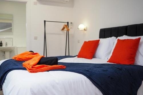 a bedroom with two beds with red and blue sheets at Private & Peaceful Double Ensuite Rooms in Stapleford in Stapleford