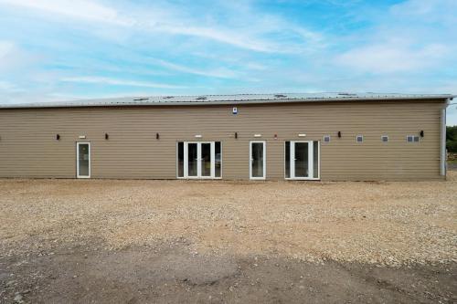 a large metal building with white doors and windows at Private & Peaceful Double Ensuite Rooms in Stapleford in Stapleford