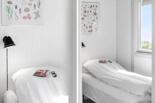 a white room with a bed and a window at G120-Lemvig-Gyvelvej-20 in Lemvig