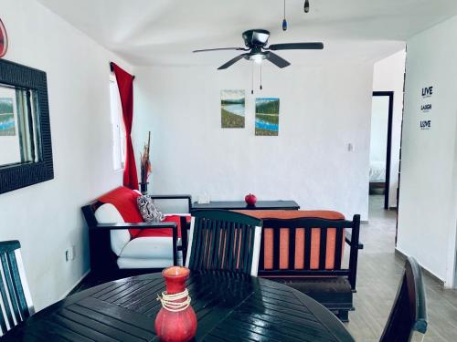 a dining room with a table and a ceiling fan at Apartments & Rooms in Cancun next to the beach in Cancún