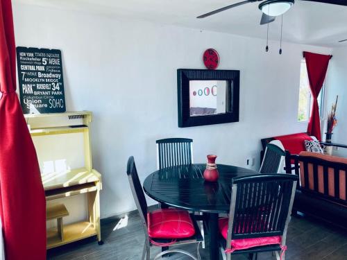 a dining room with a black table and chairs at Apartments & Rooms in Cancun next to the beach in Cancún