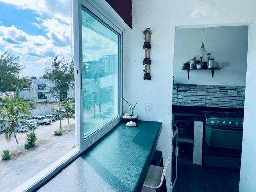 a room with a large window with a view of a street at Apartments & Rooms in Cancun next to the beach in Cancún