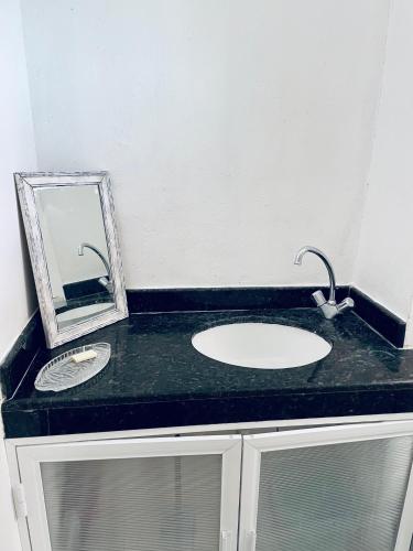 a bathroom counter with a sink and a mirror at Apartments & Rooms in Cancun next to the beach in Cancún