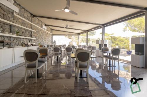 a dining room with chairs and tables in a room at HOTIDAY Room Collection - Porto Venere in Portovenere